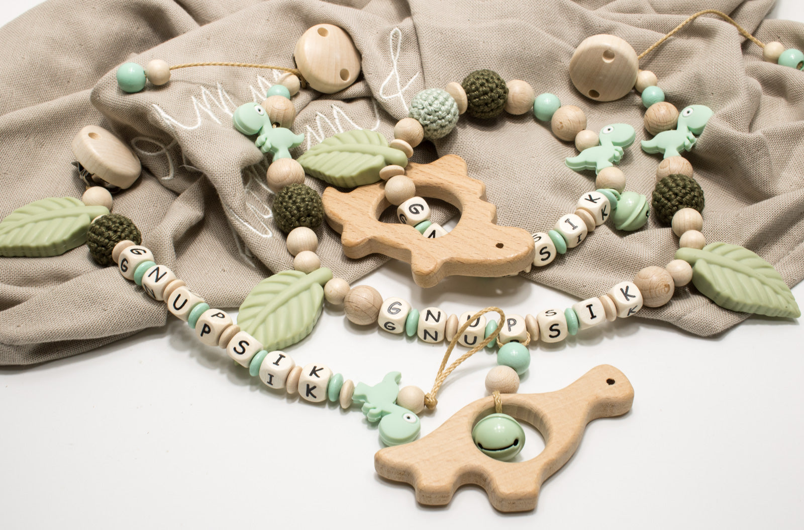 Dino Kinderwagenkette Wagenkette einzeln oder als Spar Set oliv/mint natur Holz Greifling